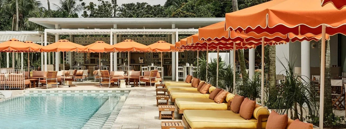 Orange parasols and yellow daybeds at Tanjong Beach Club, Singapore